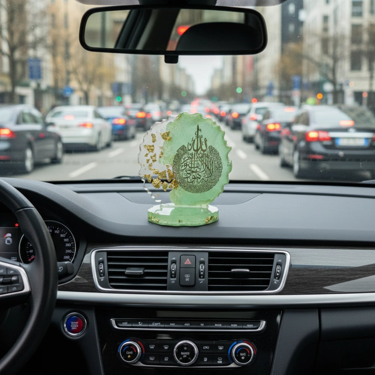 A decorative car dashboard showpiece on a car dashboard with a city street in the background by Nandak Decors 