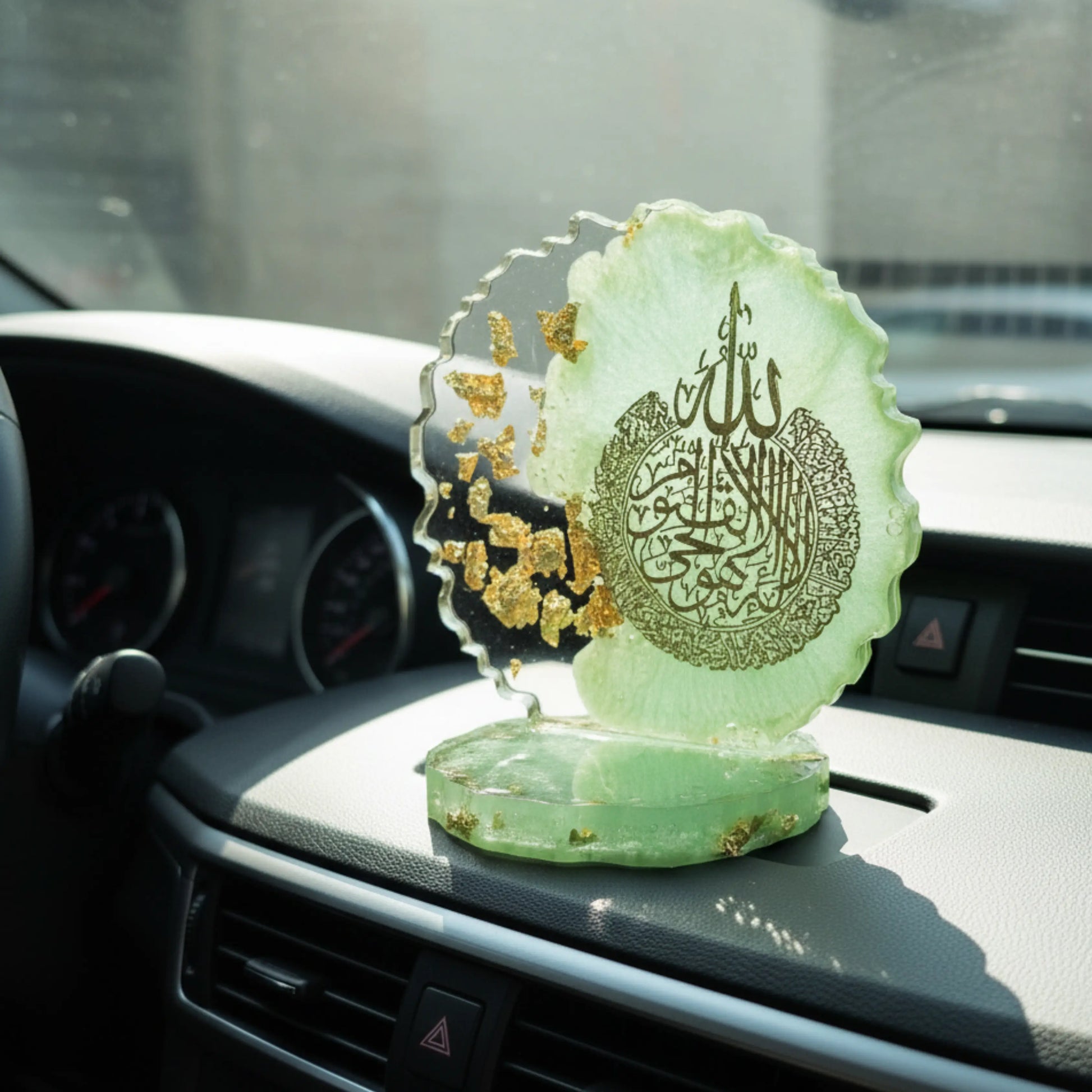 A decorative car dashboard showpiece with Arabic calligraphy on a car dashboard by Nandak Decors