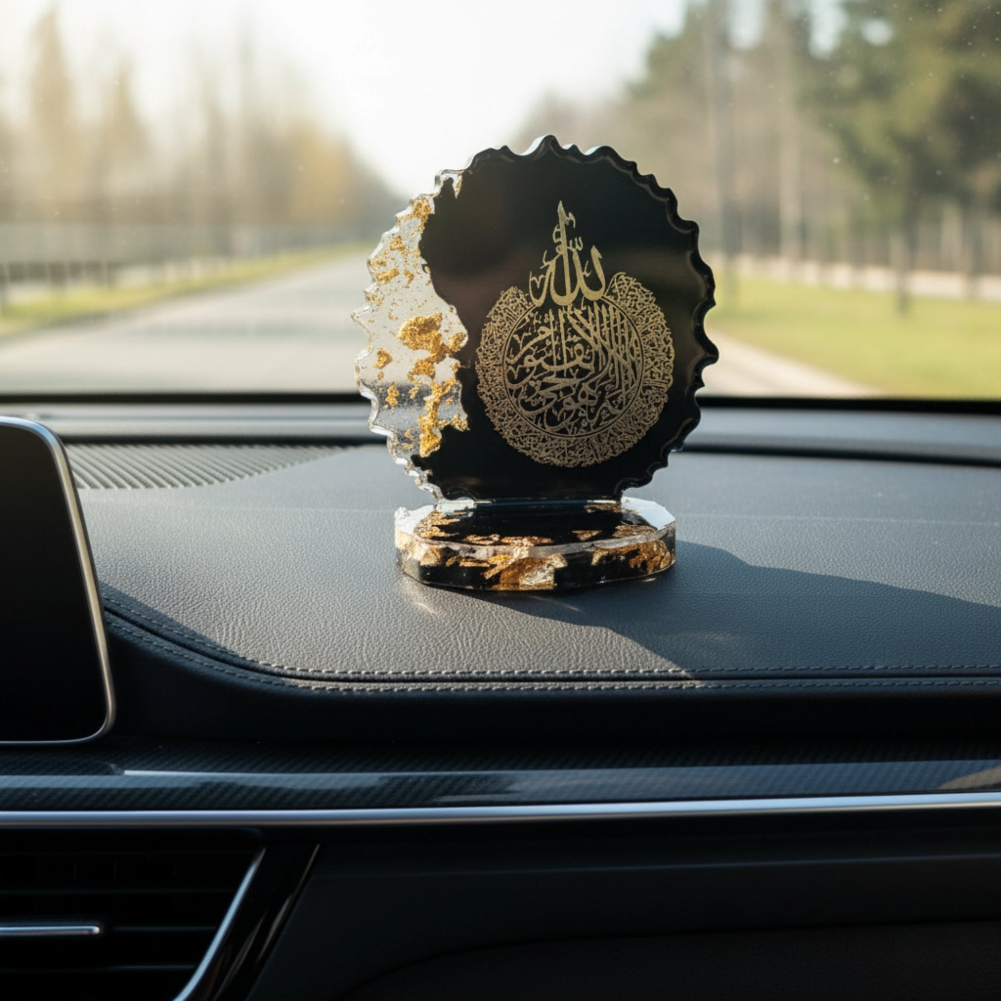 Decorative item with Arabic text on a car dashboard showpiece by Nandak Decors