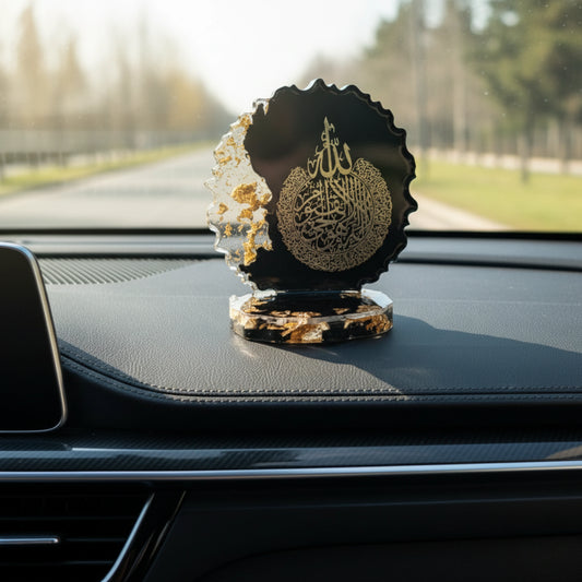 Decorative item with Arabic text on a car dashboard showpiece by Nandak Decors