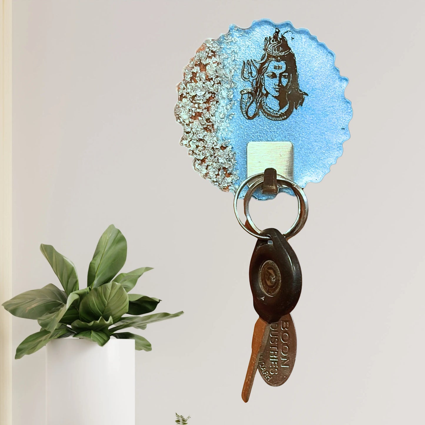 Decorative resin keyholder with Lord Siva design, crafted to stick securely to walls for everyday key storage.