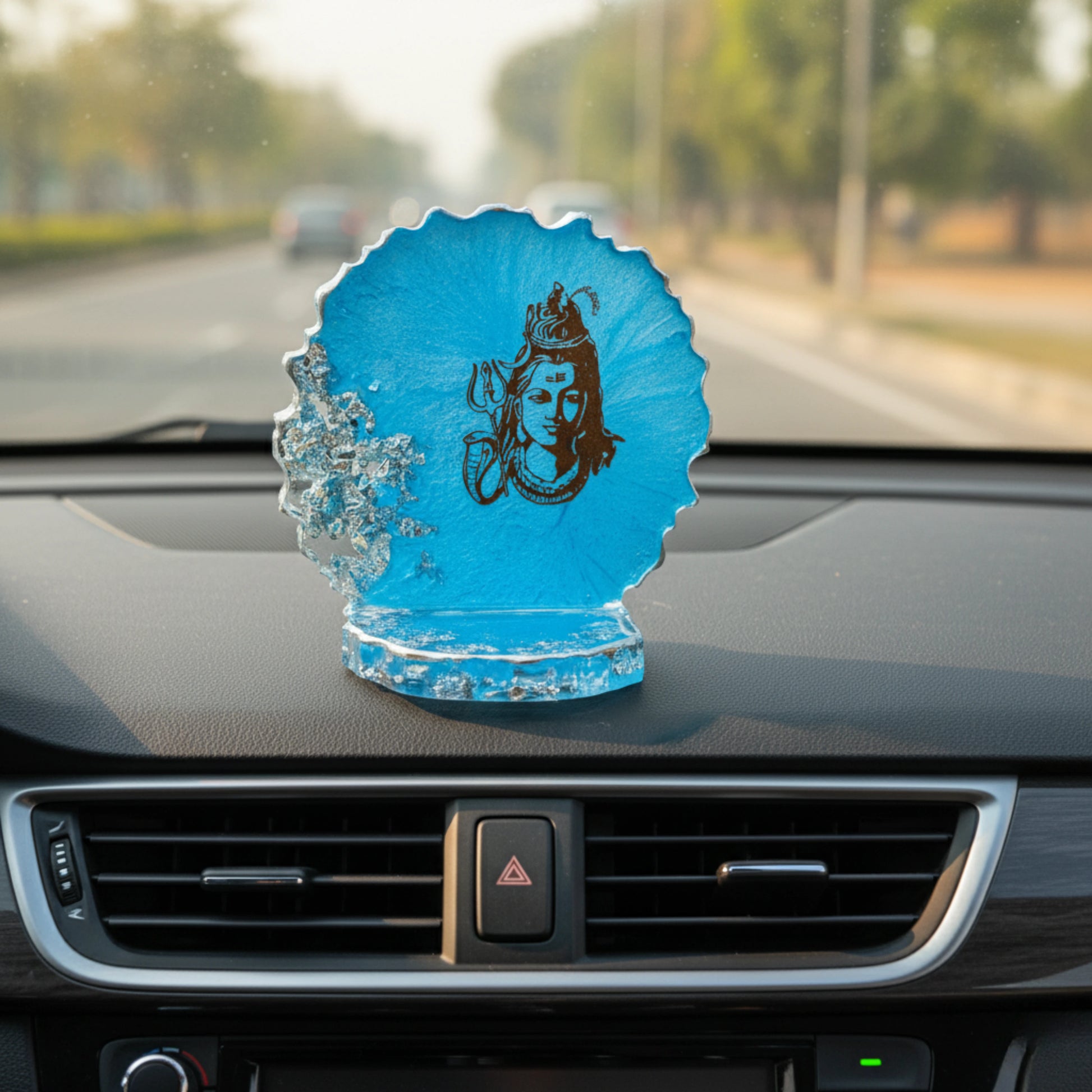Blue decorative divine car dashboard showpiece with a Lord Siva figure on a car dashboard
