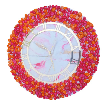 Decorative wall clock with colorful pebble-like border on a white by background by Nandakl Decors